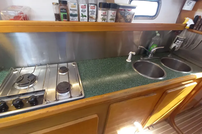 Yellowrock Yacht Photos Pics Galley kitchen in 1996 Alliaura Privilege 37 yacht with stove, sink, and spice rack.