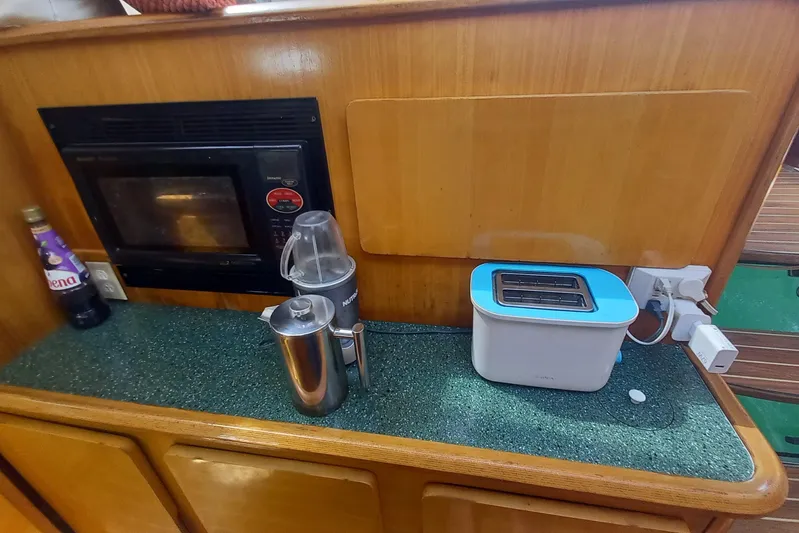 Yellowrock Yacht Photos Pics Kitchen area of 1996 Alliaura Privilege 37 yacht with appliances and wooden cabinetry.