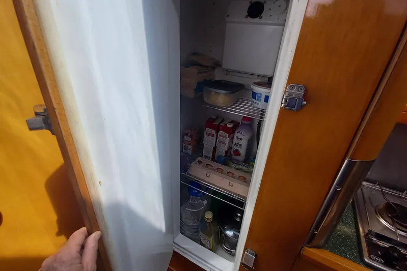 Yellowrock Yacht Photos Pics Open refrigerator on 1996 Alliaura Privilege 37 yacht, stocked with various food items.