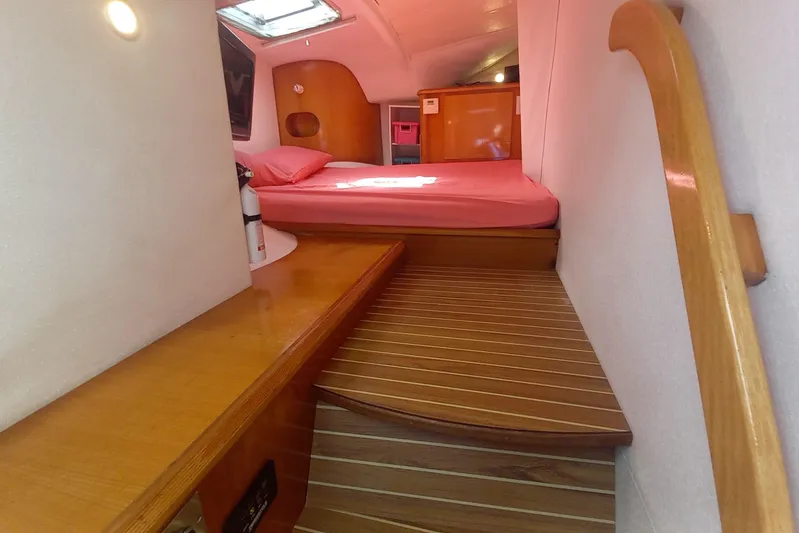 Yellowrock Yacht Photos Pics Interior cabin of 1996 Alliaura Privilege 37 catamaran with wooden steps and pink bedding.