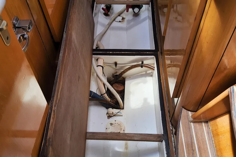 Yellowrock Yacht Photos Pics Bilge area of 1996 Alliaura Privilege 37 catamaran with visible pipes and wooden flooring.