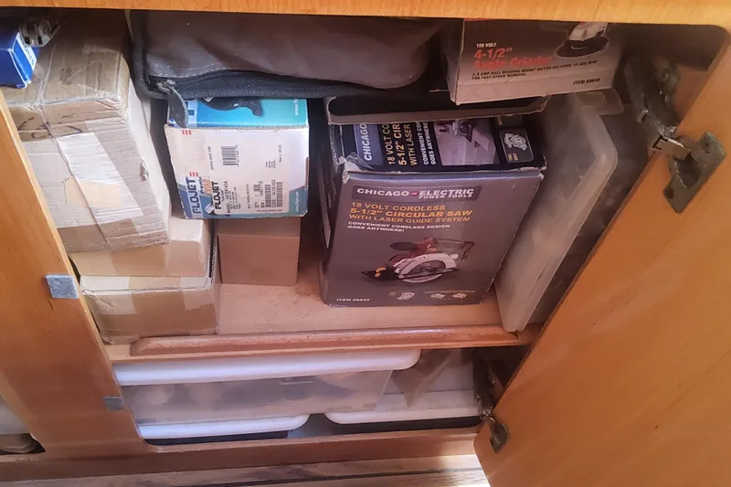 Yellowrock Yacht Photos Pics Storage cabinet on 1996 Alliaura Privilege 37, filled with tools and boxes.