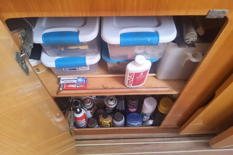 Yellowrock Yacht Photos Pics Storage cabinet on 1996 Alliaura Privilege 37 yacht with cleaning supplies and containers.