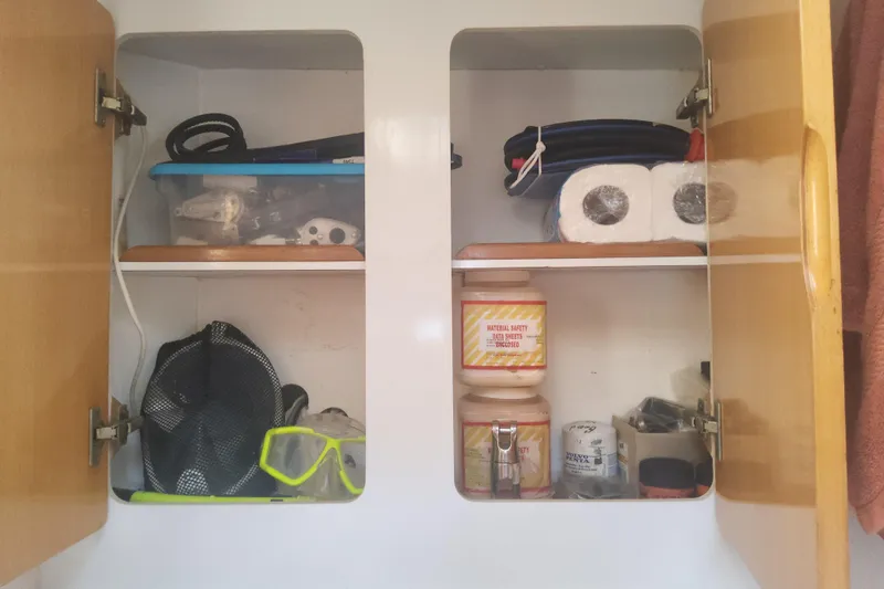 Yellowrock Yacht Photos Pics Cabinet storage on 1996 Alliaura Privilege 37 yacht with supplies and safety materials.