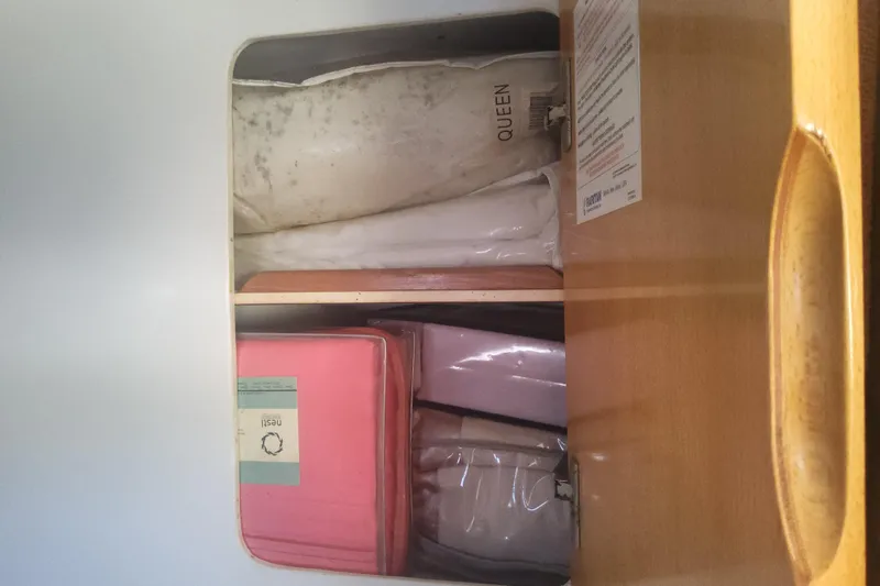 Yellowrock Yacht Photos Pics Storage compartment on a 1996 Alliaura Privilege 37 yacht with neatly organized items.