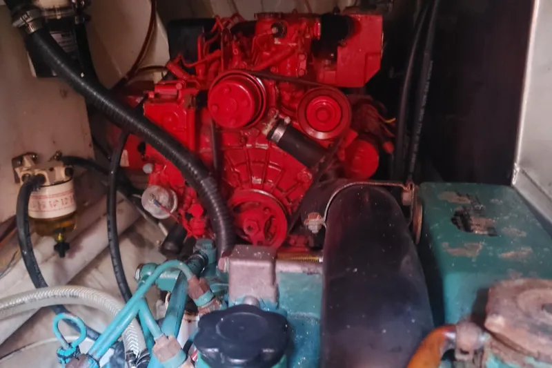 Yellowrock Yacht Photos Pics Engine compartment of a 1996 Alliaura Privilege 37 catamaran, featuring a red engine.