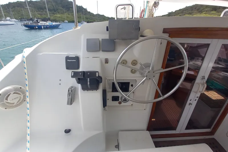 Yellowrock Yacht Photos Pics Cockpit of 1996 Alliaura Privilege 37 catamaran with steering wheel and navigation equipment.
