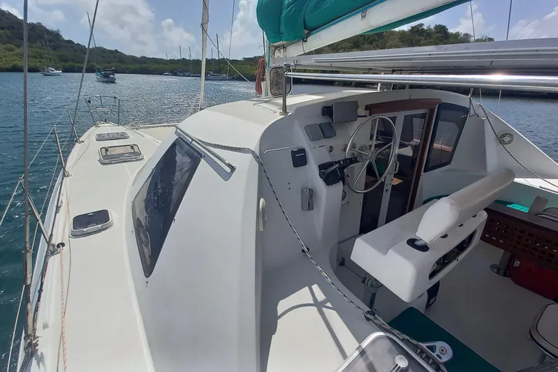 Yellowrock Yacht Photos Pics 1996 Alliaura Privilege 37 catamaran cockpit with steering wheel, docked in a scenic bay.