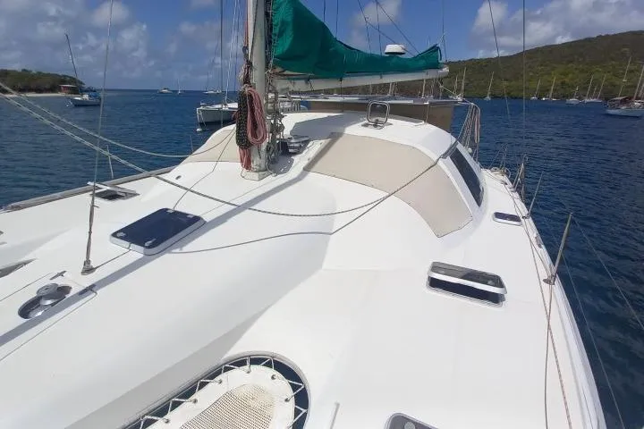 Yellowrock Yacht Photos Pics 1996 Alliaura Privilege 37 catamaran with green sail, anchored in a scenic bay.