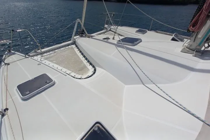 Yellowrock Yacht Photos Pics 1996 Alliaura Privilege 37 catamaran deck with hatches and netting, sailing on calm waters.