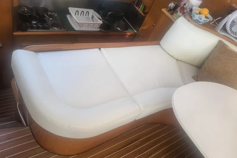 Yellowrock Yacht Photos Pics Luxurious interior of 1996 Privilege 37 yacht with white seating and wooden flooring.