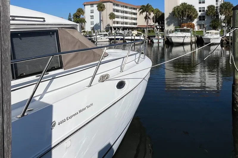 Two Can Do It II Yacht Photos Pics 2000 Cruisers Yachts 4450 Motor Yacht docked in a marina.