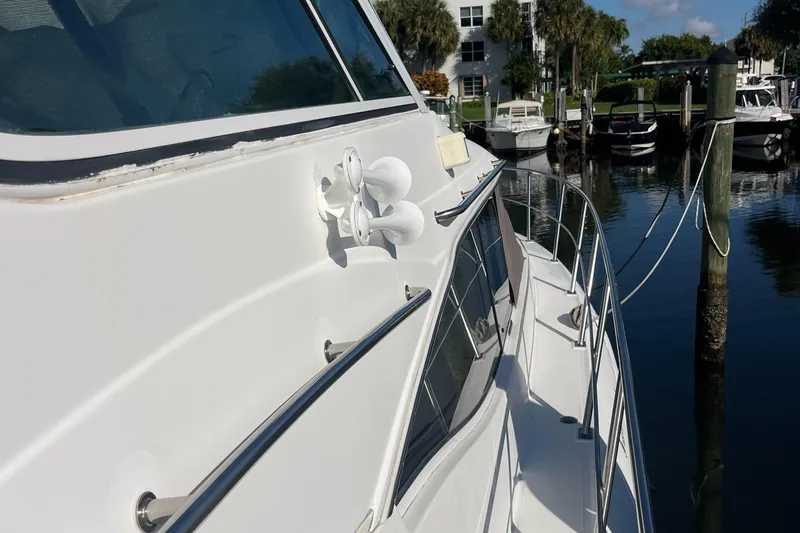 Two Can Do It II Yacht Photos Pics 2000 Cruisers Yachts 4450 Motor Yacht docked at marina, side view.