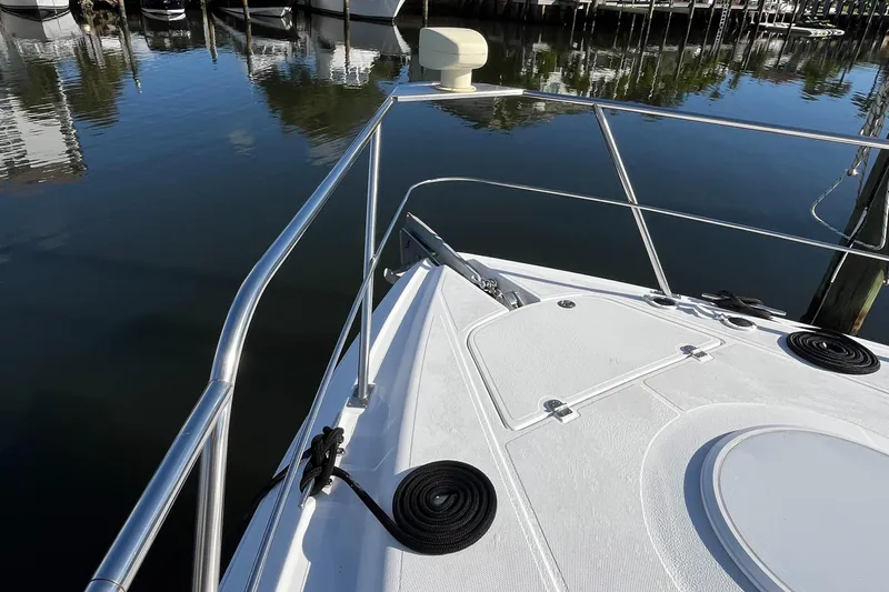 Two Can Do It II Yacht Photos Pics Bow of 2000 Cruisers Yachts 4450 Motor Yacht docked in calm marina waters.