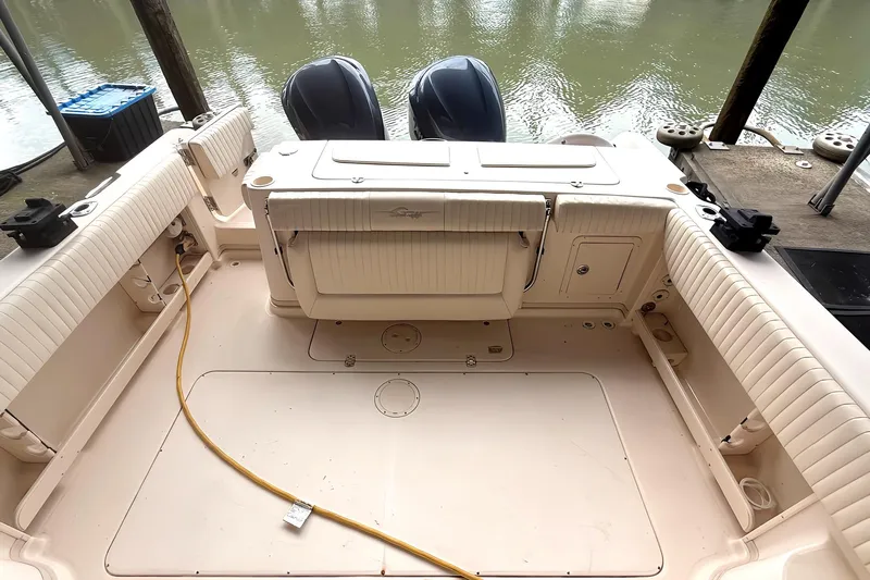 Yacht Photos Pics 2007 Grady-White Express 305 boat interior with seating and storage, docked by the water.