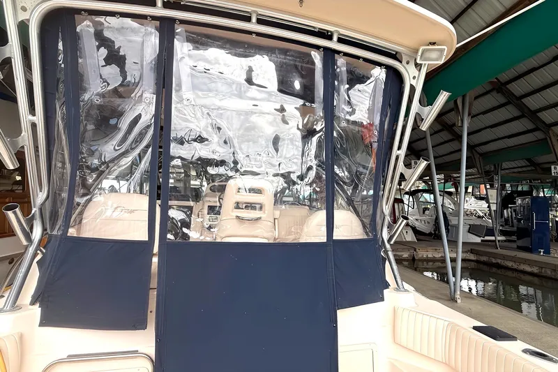  Yacht Photos Pics 2007 Grady-White Express 305 boat with clear enclosure, docked in a marina.