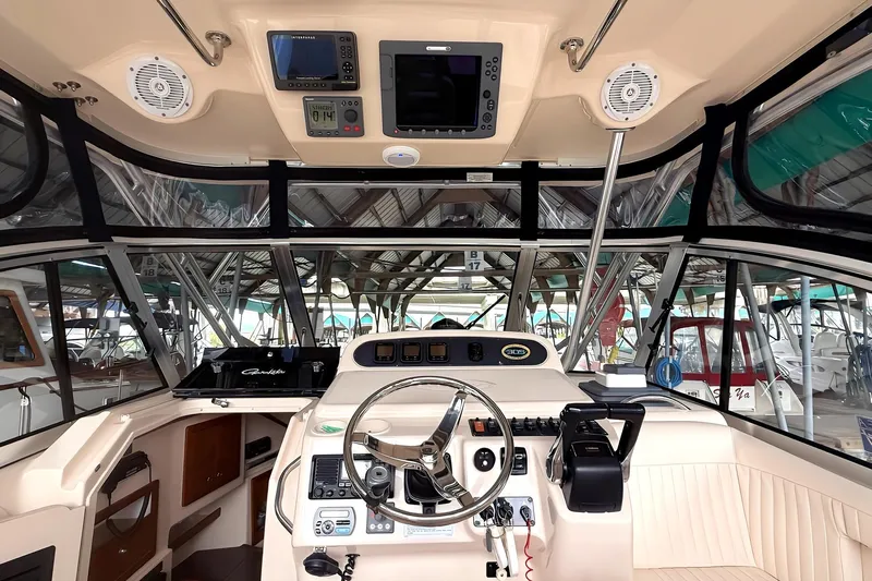  Yacht Photos Pics 2007 Grady-White Express 305 boat cockpit with steering wheel and navigation equipment.