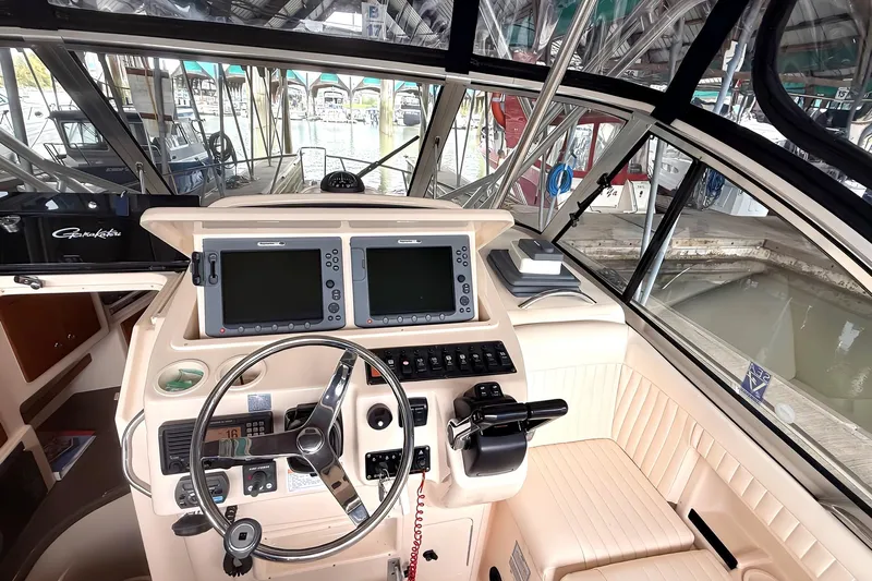  Yacht Photos Pics 2007 Grady-White Express 305 boat cockpit with dual navigation screens and steering wheel.