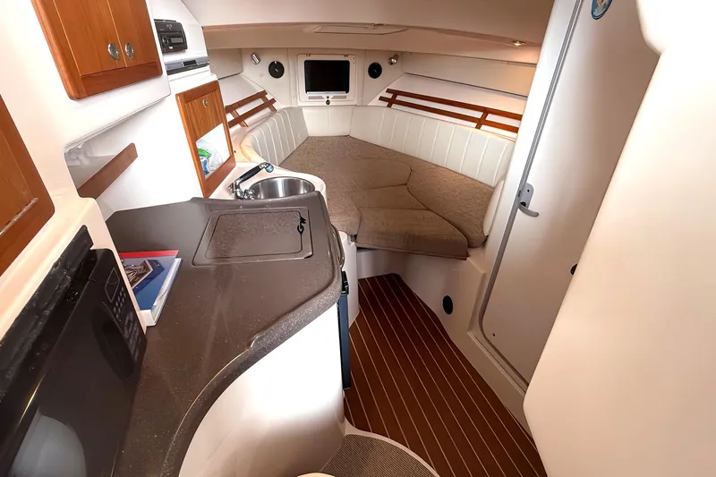  Yacht Photos Pics 2007 Grady-White Express 305 cabin interior with kitchenette and cozy sleeping area.