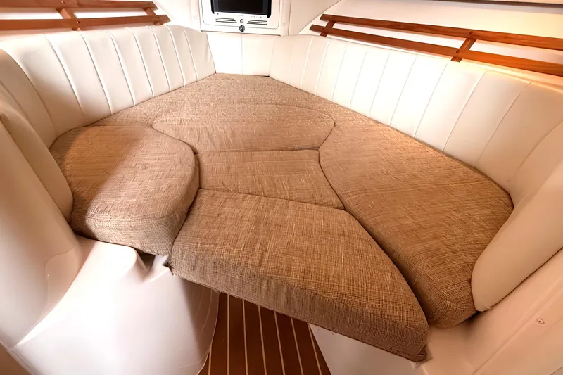  Yacht Photos Pics 2007 Grady-White Express 305 cabin interior with beige cushions and white seating.