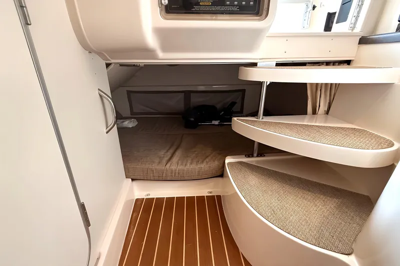  Yacht Photos Pics 2007 Grady-White Express 305 cabin interior with steps and sleeping area.
