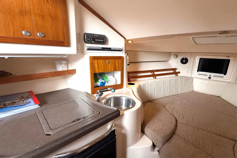  Yacht Photos Pics 2007 Grady-White Express 305 cabin interior with kitchenette, sink, and cozy seating area.