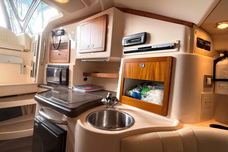  Yacht Photos Pics 2007 Grady-White Express 305 boat interior with kitchenette, sink, and storage cabinets.
