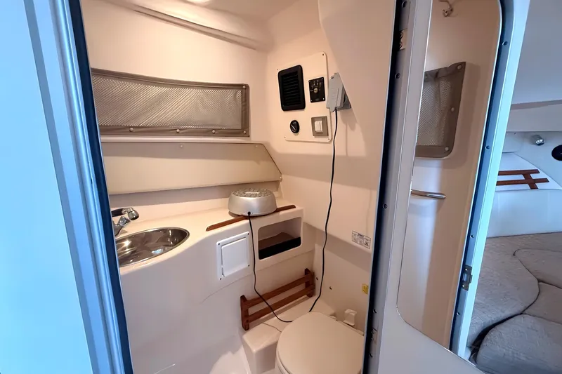  Yacht Photos Pics 2007 Grady-White Express 305 boat interior with compact bathroom and sink.