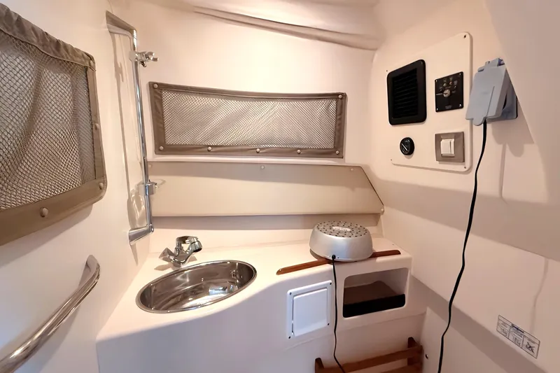  Yacht Photos Pics 2007 Grady-White Express 305 boat interior with sink and storage compartments.