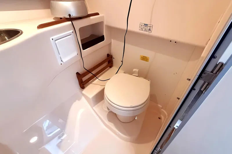  Yacht Photos Pics 2007 Grady-White Express 305 boat bathroom with toilet and storage compartments.