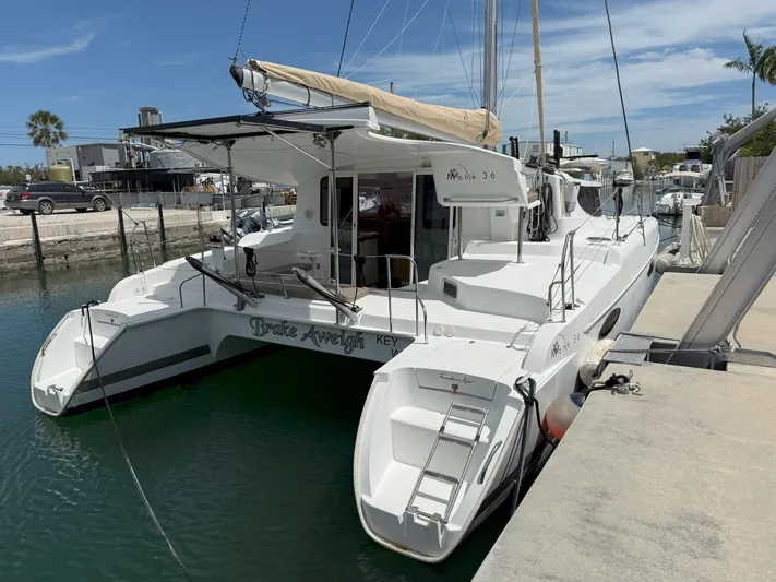 Brake Aweigh Yacht Photos Pics 2014 Fountaine Pajot Mahe 36 Evolution catamaran docked in a marina.