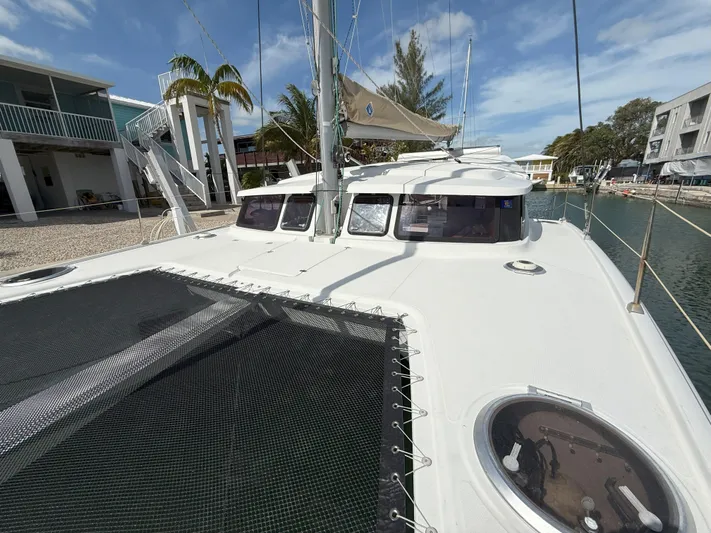Brake Aweigh Yacht Photos Pics 2014 Fountaine Pajot Mahe 36 Evolution catamaran docked, showcasing deck and netting.