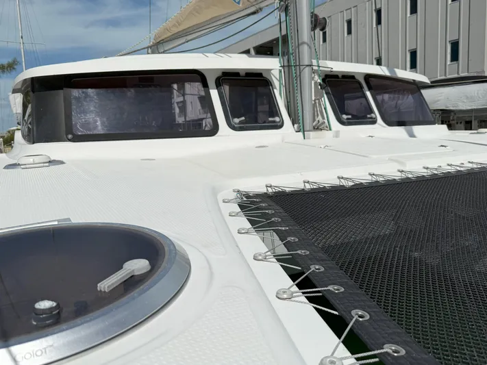 Brake Aweigh Yacht Photos Pics 2014 Fountaine Pajot Mahe 36 Evolution catamaran deck with netting and windows.