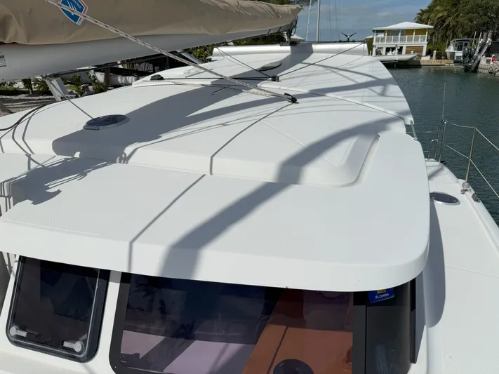 Brake Aweigh Yacht Photos Pics 2014 Fountaine Pajot Mahe 36 Evolution catamaran, docked, top view of deck and sail.