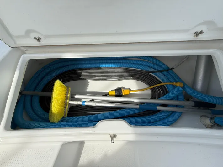 Brake Aweigh Yacht Photos Pics Storage compartment with hoses and cleaning tools on a 2014 Fountaine Pajot Mahe 36 Evolution.