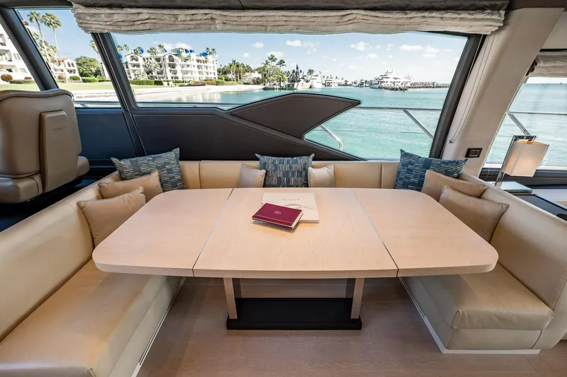 Amici Yacht Photos Pics Luxurious interior of 2017 Azimut 66 yacht with elegant dining area and scenic ocean view.