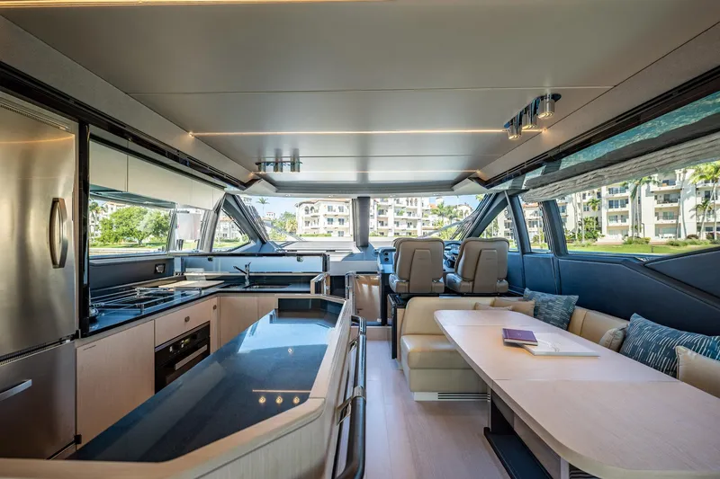 Amici Yacht Photos Pics Luxurious interior of a 2017 Azimut 66 yacht with modern kitchen and seating area.