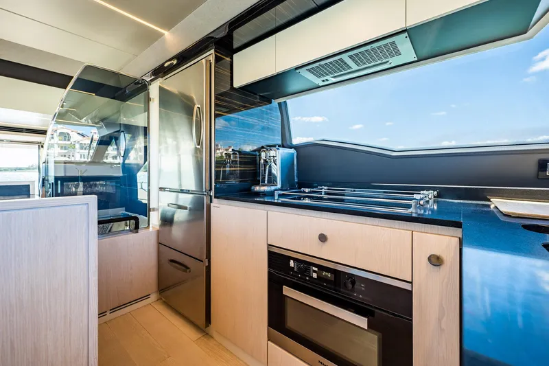Amici Yacht Photos Pics Modern kitchen interior of 2017 Azimut 66 yacht with sleek appliances and ocean view.