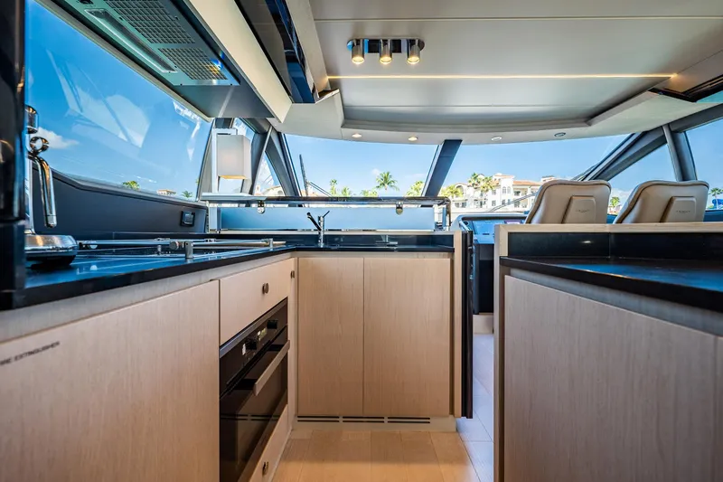 Amici Yacht Photos Pics Luxurious interior of 2017 Azimut 66 yacht with modern kitchen and panoramic windows.