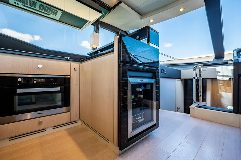 Amici Yacht Photos Pics Luxurious interior of 2017 Azimut 66 yacht featuring modern kitchen appliances and sleek design.