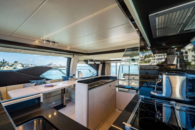 Amici Yacht Photos Pics Luxurious interior of 2017 Azimut 66 yacht with modern kitchen and dining area.