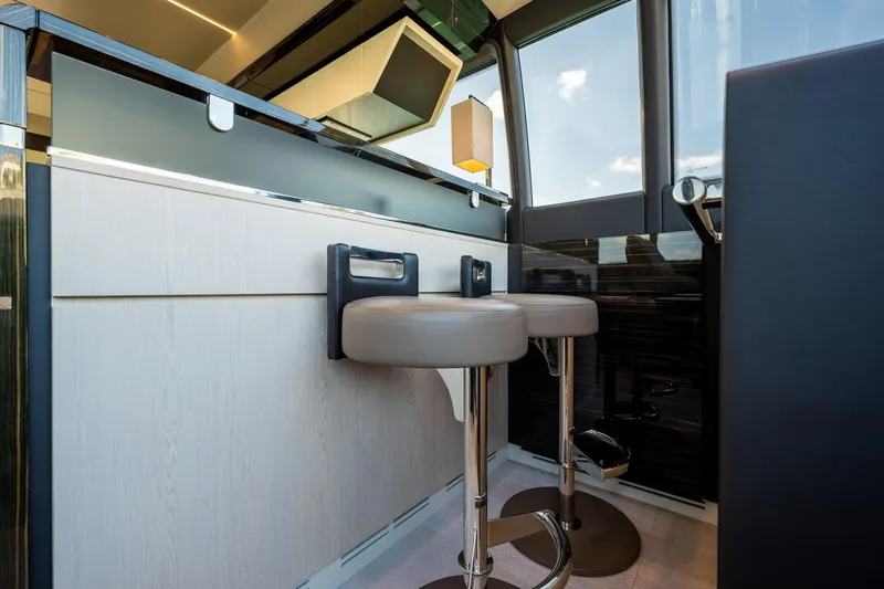 Amici Yacht Photos Pics Modern interior of 2017 Azimut 66 yacht with sleek bar stools and stylish design.