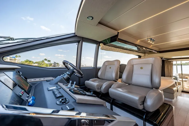 Amici Yacht Photos Pics Luxurious interior of 2017 Azimut 66 yacht with modern helm and plush seating.