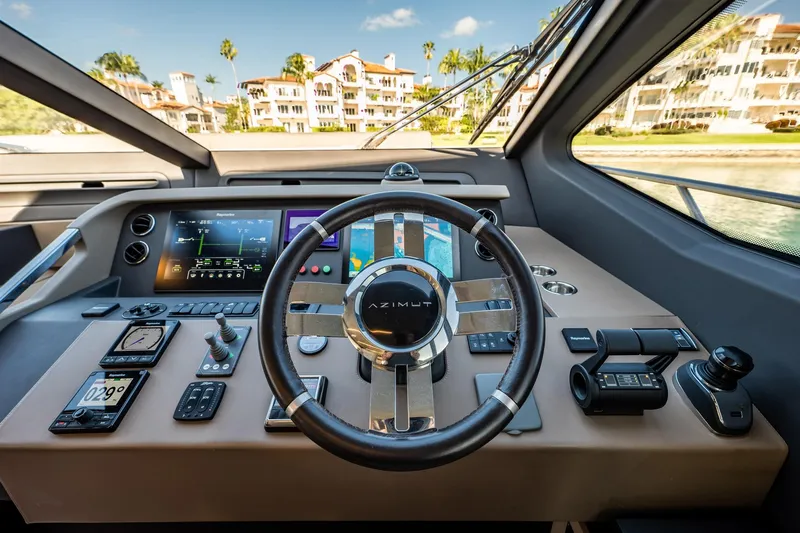 Amici Yacht Photos Pics Cockpit of 2017 Azimut 66 yacht with modern navigation controls and steering wheel.