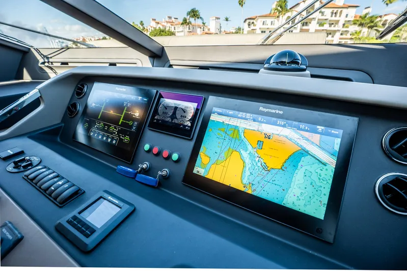 Amici Yacht Photos Pics Control panel of a 2017 Azimut 66 yacht with navigation screens and controls.