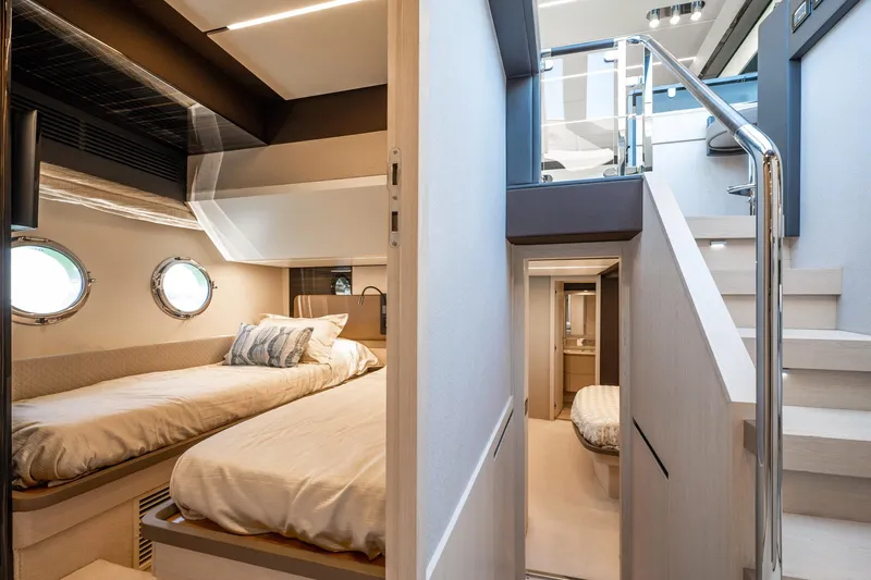 Amici Yacht Photos Pics Luxurious interior of 2017 Azimut 66 yacht featuring cozy twin beds and modern design.