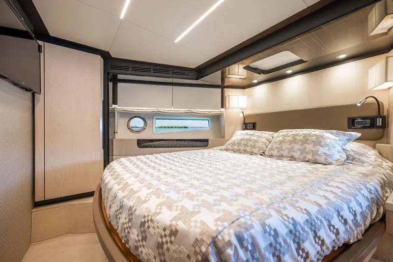 Amici Yacht Photos Pics Luxurious bedroom interior of 2017 Azimut 66 yacht with modern design and cozy bedding.