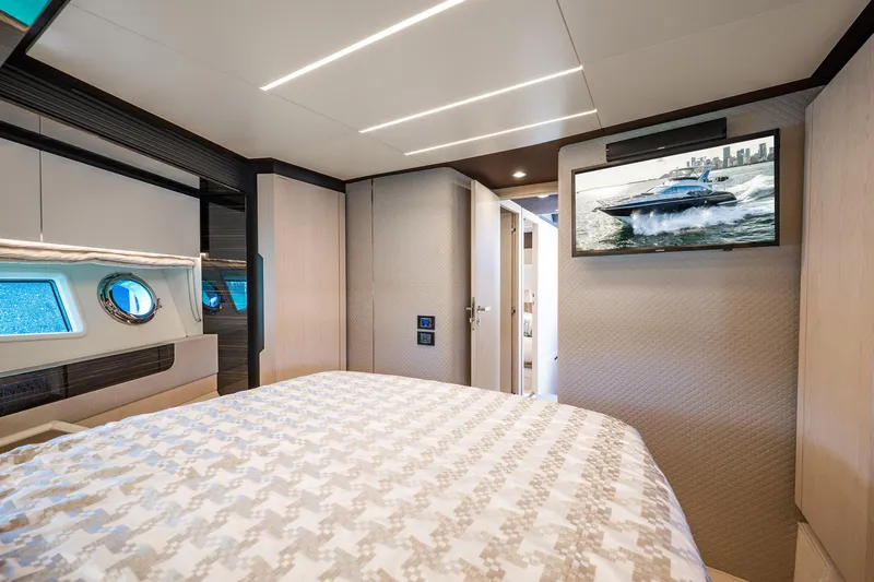 Amici Yacht Photos Pics Luxurious bedroom interior of 2017 Azimut 66 yacht with modern decor and TV.