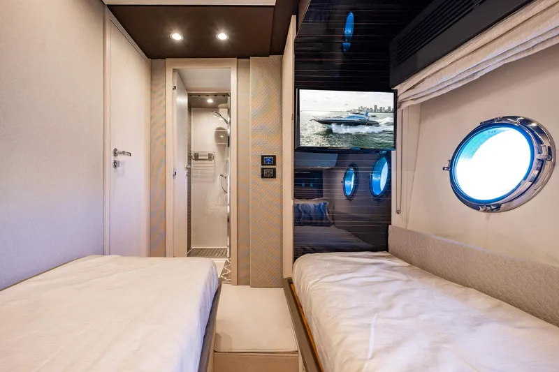 Amici Yacht Photos Pics Luxurious 2017 Azimut 66 yacht cabin with twin beds and porthole windows.