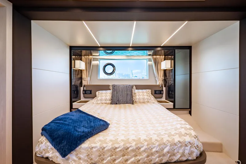 Amici Yacht Photos Pics Luxurious bedroom interior of 2017 Azimut 66 yacht with elegant bedding and modern lighting.